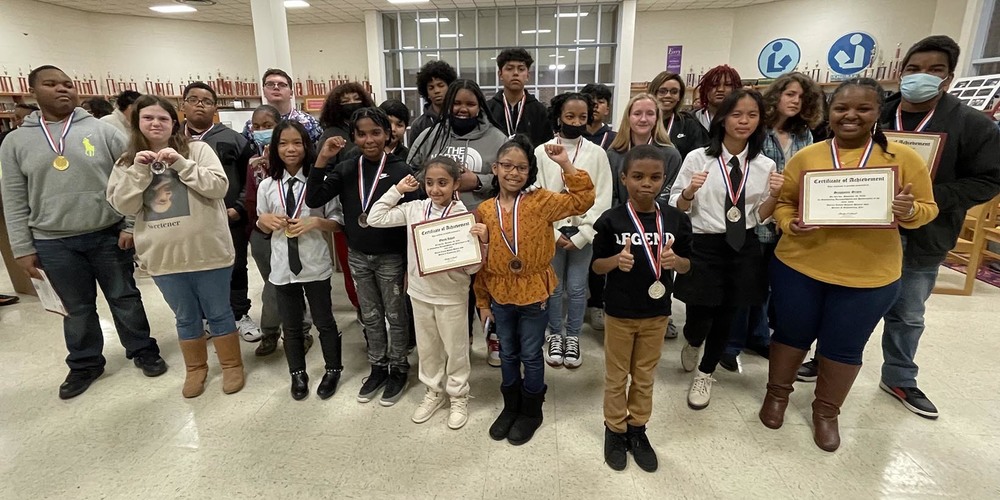 Science and Engineering Fair winners with their awards and medals