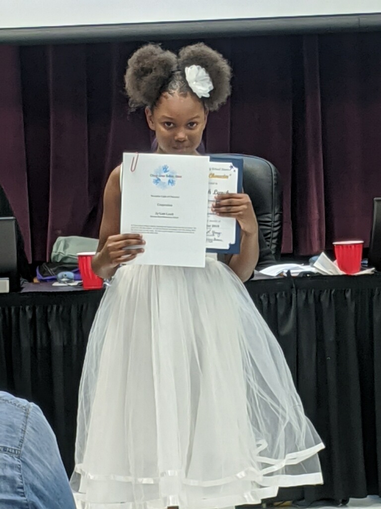 Zy'Liah Lynch accepts the "Light of Character" award for "Cooperation"
